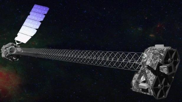 这张插图显示了 NASA 在太空中的 NuSTAR X 射线望远镜。两个笨重的部件由一个 33 英尺（10 米）的结构隔开，该结构称为可展开桅杆或吊杆。光在吊杆的一端收集，并沿其长度聚焦，然后撞击另一端的检测器.jpg