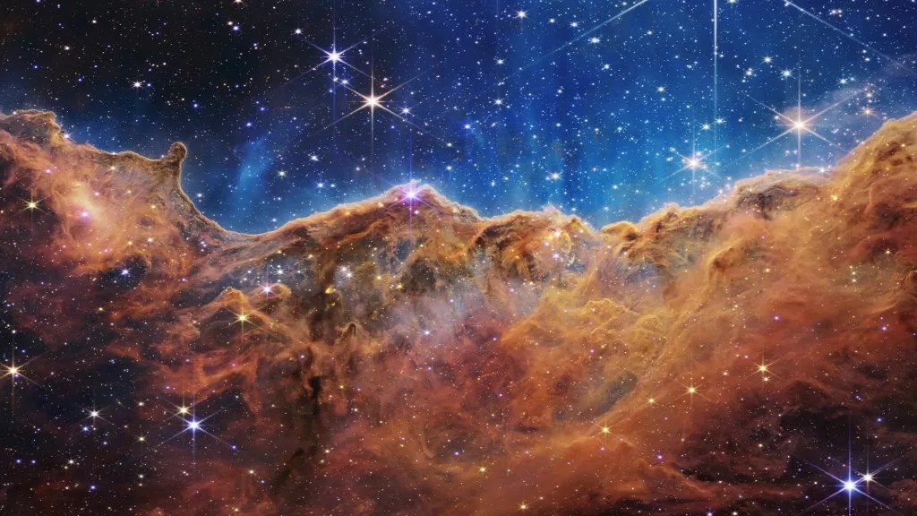 船底座星云中宇宙悬崖的合成图像，由韦伯望远镜的 NIRCam 和 MIRI 仪器创建.webp.jpg